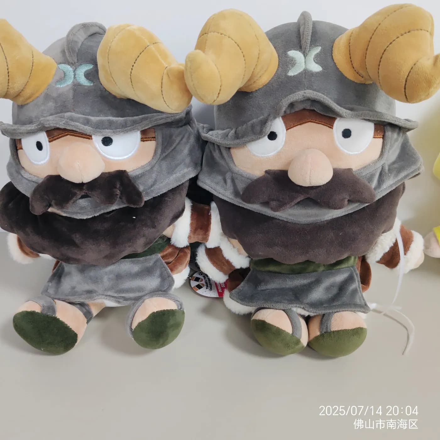 Pair of bearded knight character plush toys in printed armour