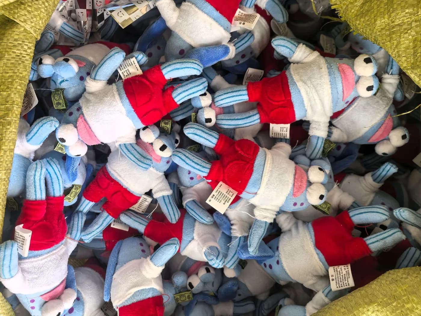 Bulk run of red, cream and blue character charms on the packing table