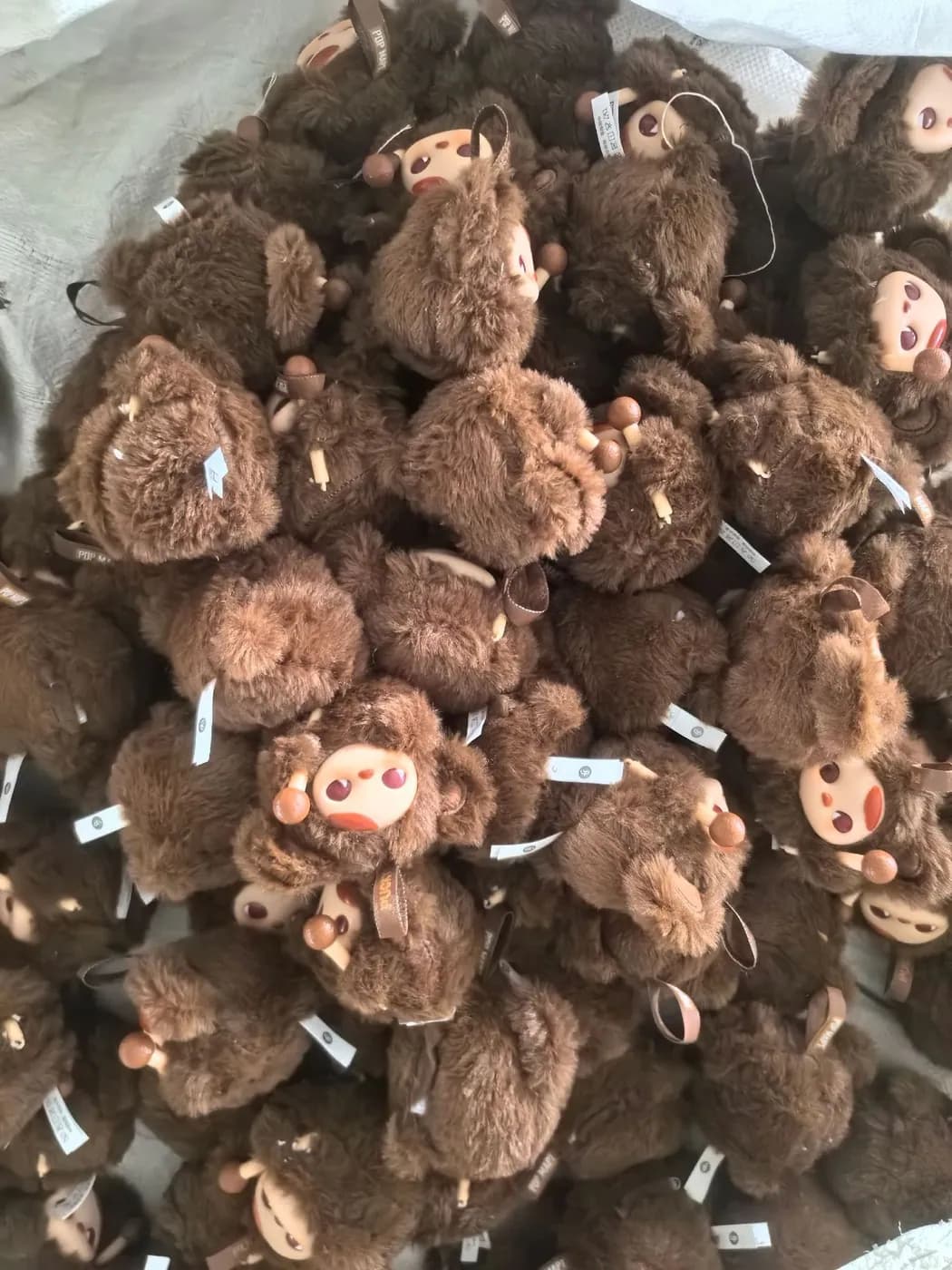 Bulk run of brown curly-pile character charms