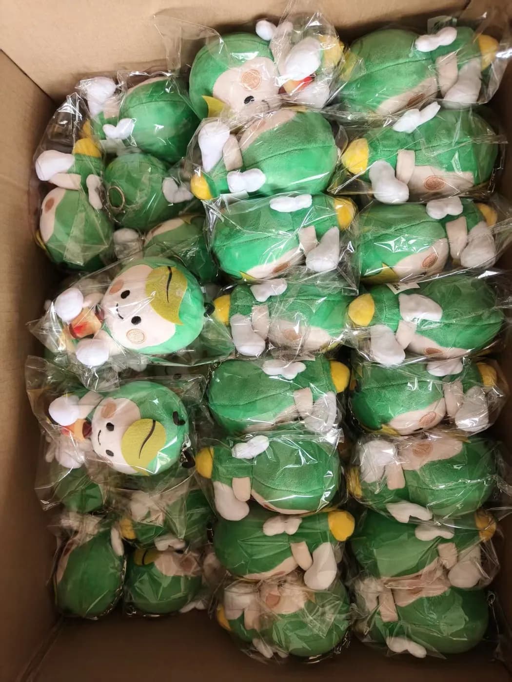Green character plush individually bagged before packing