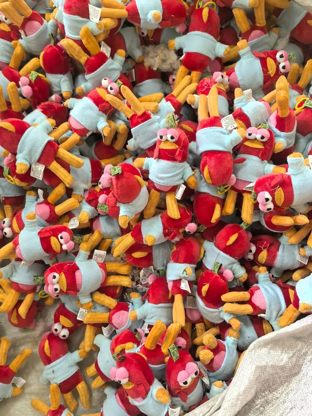 Bulk run of red and pale blue character charms with yellow arms