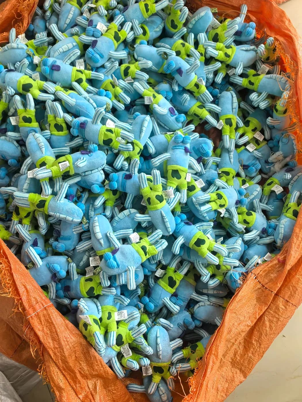 Bulk run of teal character charms after sewing