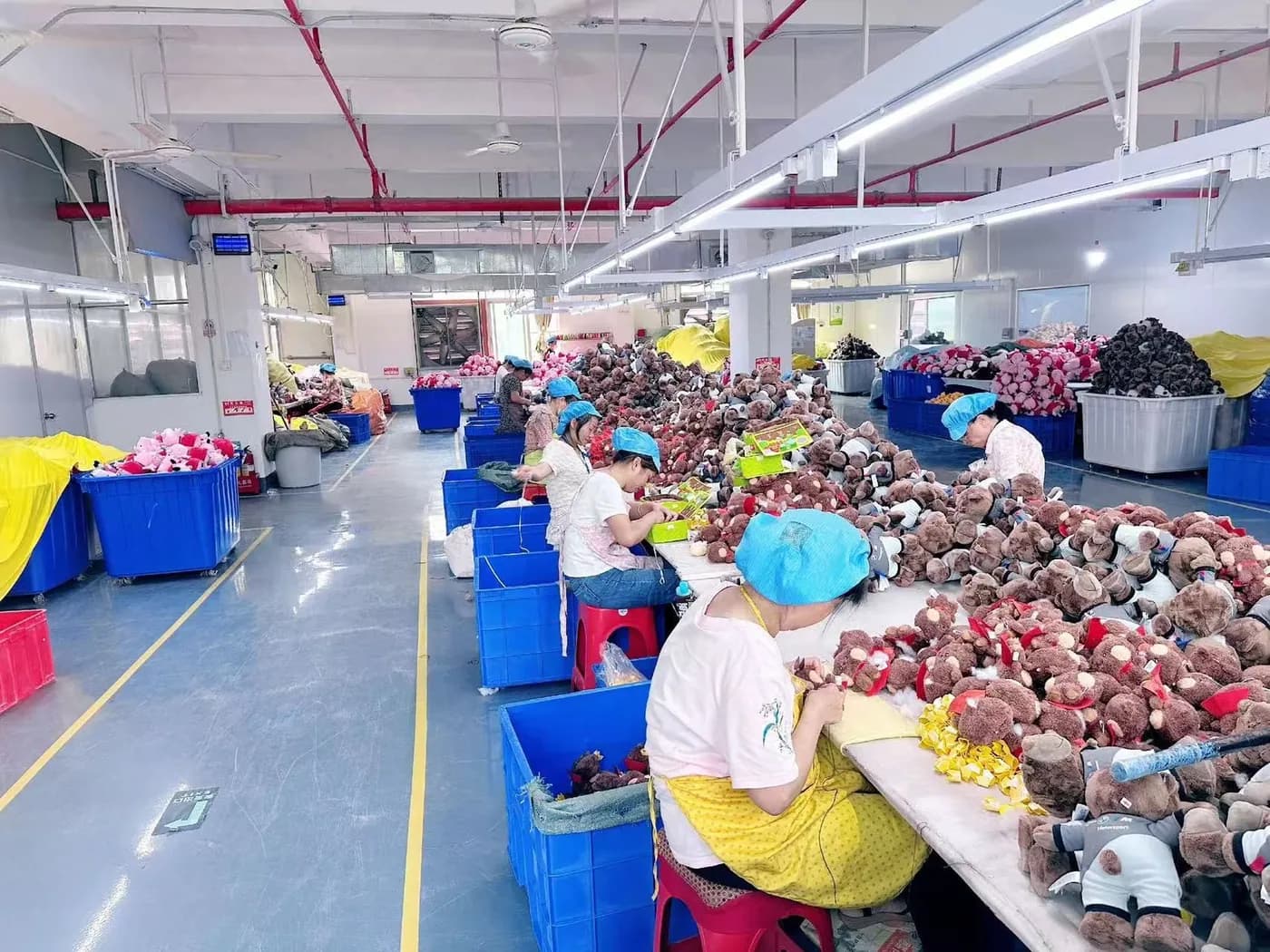 Operators sorting and finishing plush along the production line