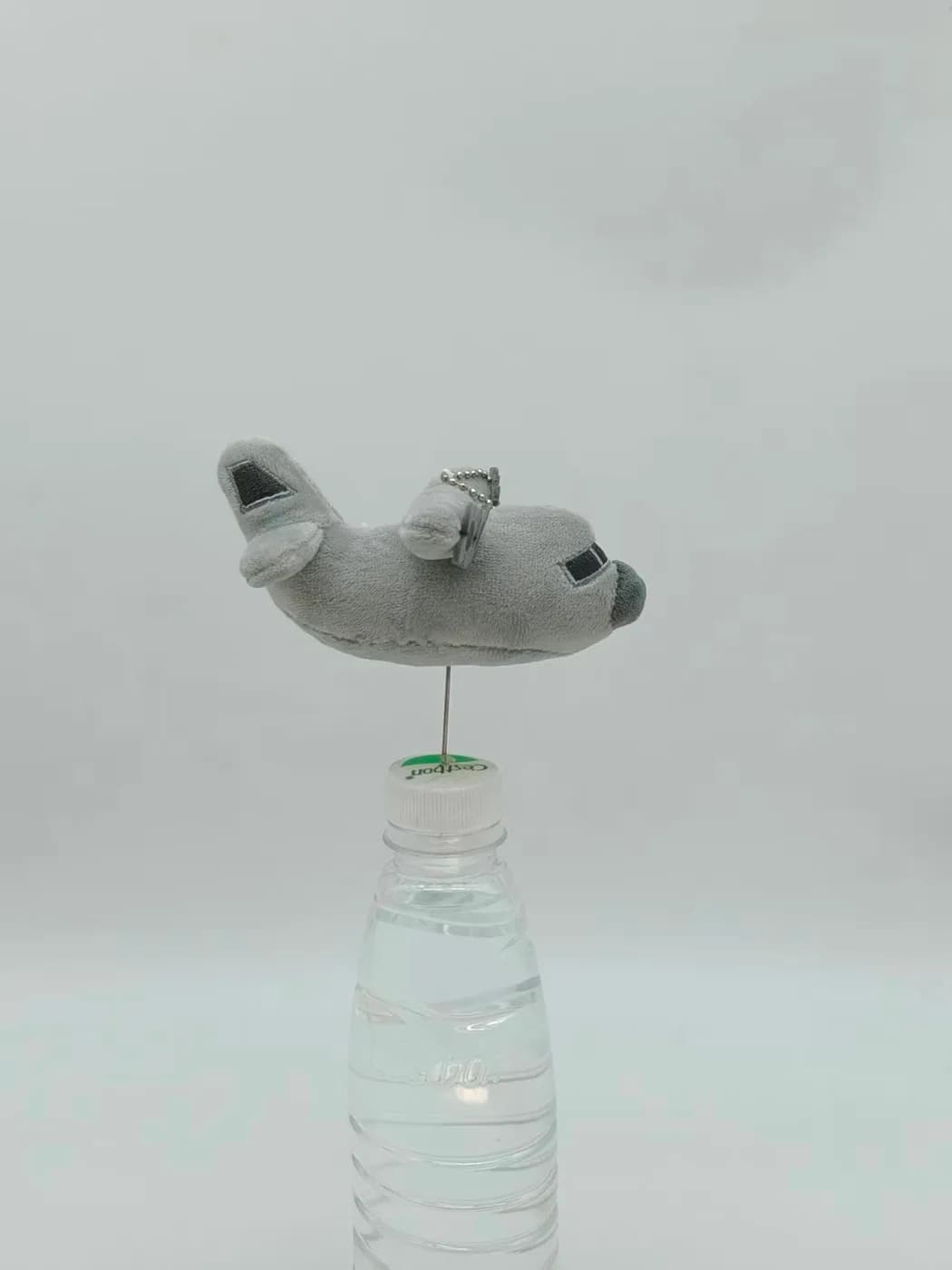 Aircraft plush charm seen from the side, showing the wing panels