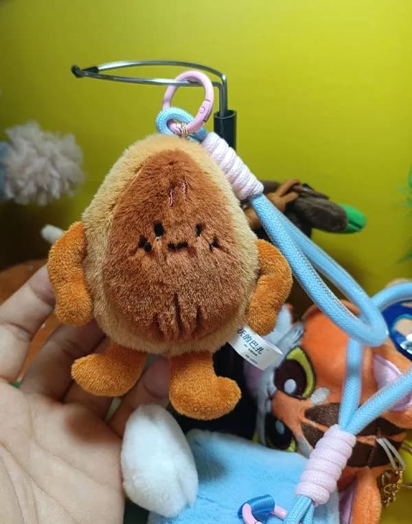 Crab character plush charm clipped to a braided carabiner strap