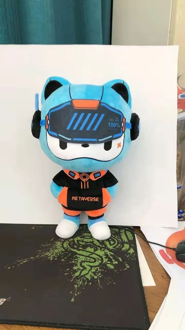 Teal cat mascot plush in a printed brand T-shirt