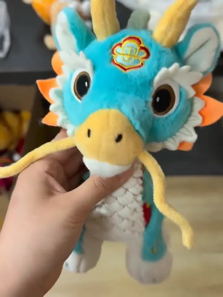 A finished dragon sample turned under the light. This is the only view in which the embroidery, the pile direction and the seam lines can actually be judged — which is why every approval sample is filmed this way before a bulk run starts.